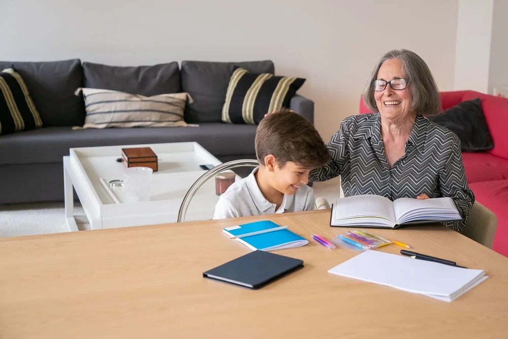 A grandmother helping her grandson with learning at home.