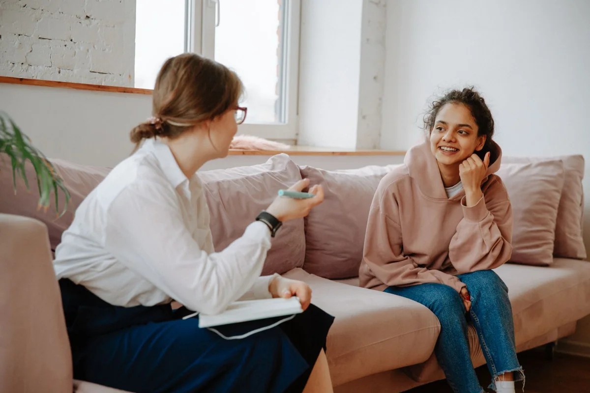 Two women talking in a comfortable office.