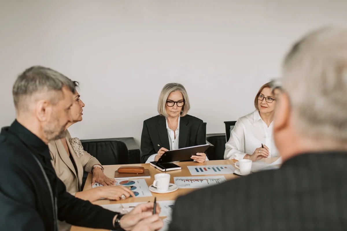 Colleagues reviewing information around a meeting table.